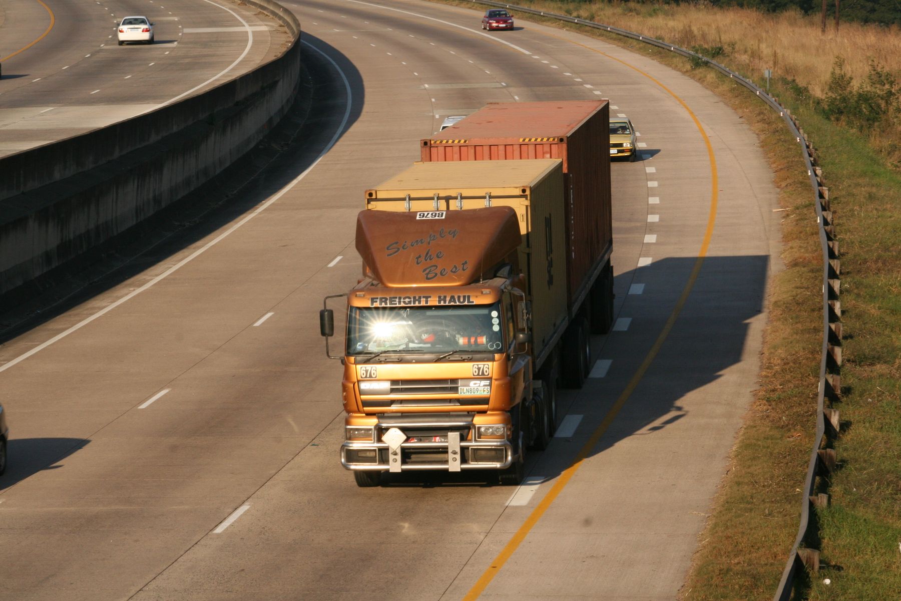 Container truck traveling along a highway
